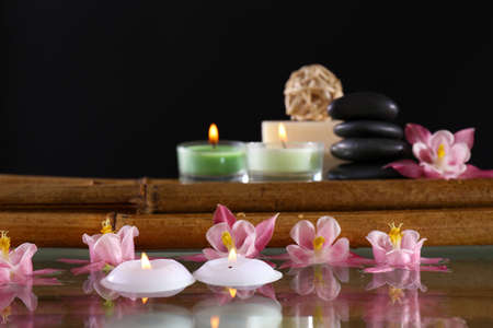 Spa still life with flowers and candlelight on black backgroundの写真素材