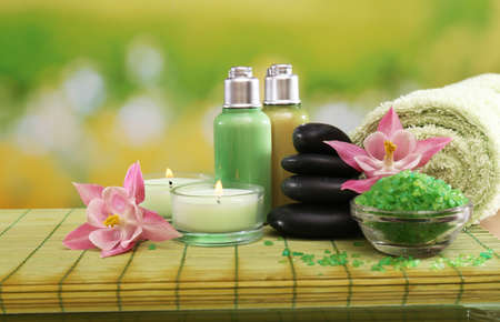 Spa still life with flowers and candlelight on green blurred backgroundの写真素材