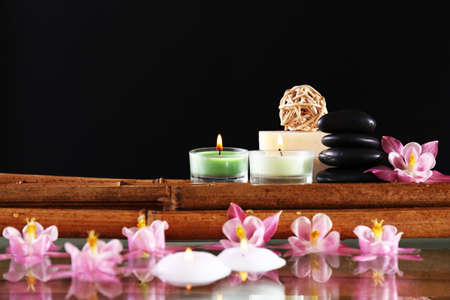 Spa still life with flowers and candlelight on black backgroundの写真素材