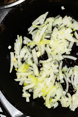 onions are baked in a frying panの写真素材