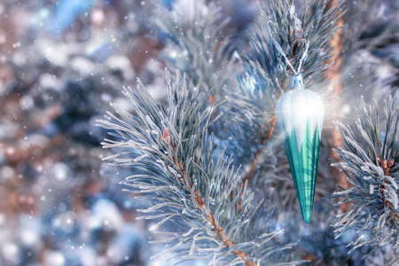 Christmas or New year composition. Christmas toys on spruce. Snowflakes, and glare.の写真素材