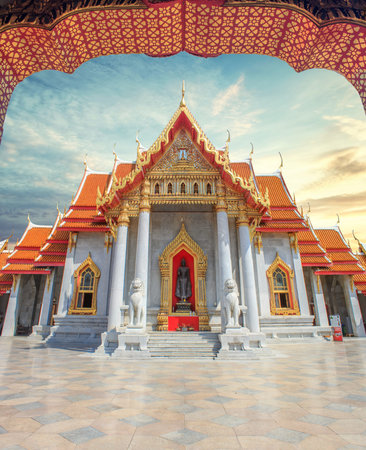 Famous marble Buddhist temple or Wat Benchamabophit in Bangkok, Thailand with sunset sky
