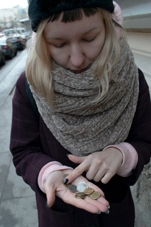 girl holds a small change in her palm. grey gamut