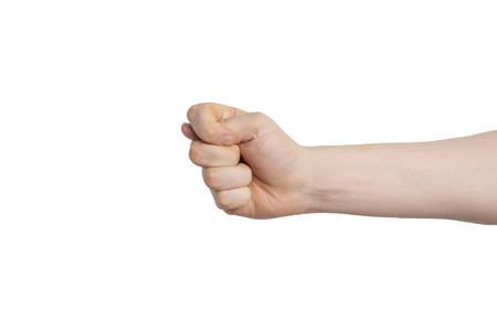 A fist with a thumb between the index and middle fingers is a rude gesture. Fig on an isolated background. Horizontal photo.の写真素材