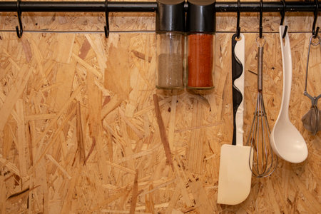 The design of the modern home kitchen in the loft-style and rustic. wooden wall with kitchen...