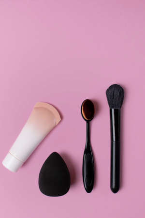 Cosmetics and accessories on a pink background. flat layの写真素材