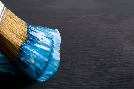 paint brush painting with blue color. close-up. dark background. copy spaceの写真素材