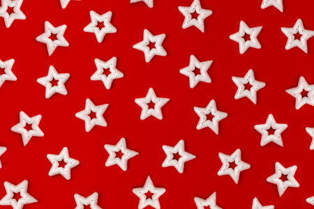 many white stars on a bright red background. Pattern of Christmas decorations