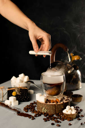 Mug Of Coffee with steam . Sugar And handful Of coffee baens. Christmas Decorations. blue and black backgroundの写真素材