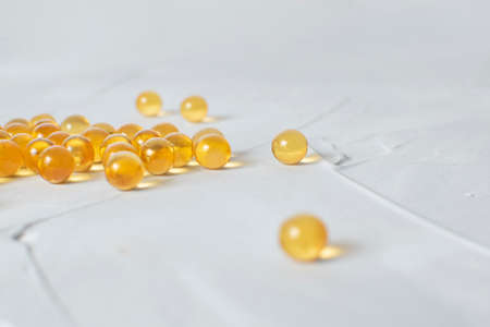 Cod Liver Oil Capsules pills on grey backgound.の写真素材
