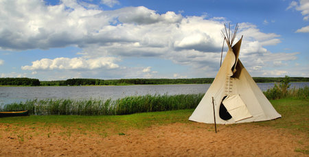 Indian ethnic domicile, teepee aka wigwam on the lake.の写真素材