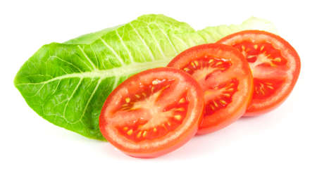 Tomato slices with salad leaf on white backgroundの写真素材