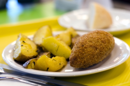 A chicken kiev close-up with chips, or French fries.の写真素材