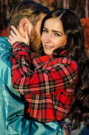 Couple embracing in autumn parkの写真素材