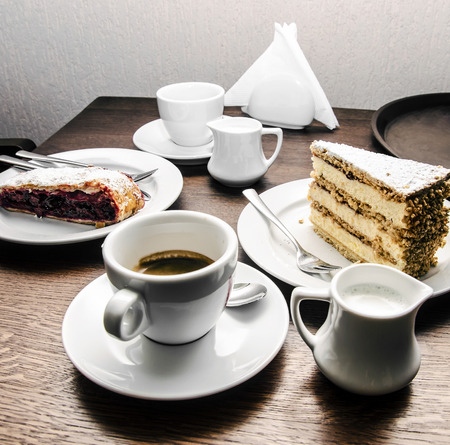 Two cups of coffee, milk, cake and dessertの写真素材