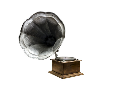Retro old gramophone with horn speaker for playing music over plates isolated on whiteの写真素材