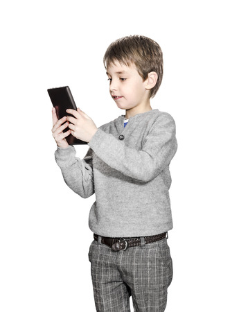 Boy with tablet computer isolated on white. Child holding tablet.の写真素材
