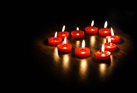Heart of the candles on the texture of woodの写真素材