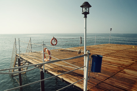 Wooden pier or jetty on a blue oceanの写真素材