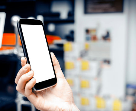 Woman holding a big black smartphone in handの写真素材