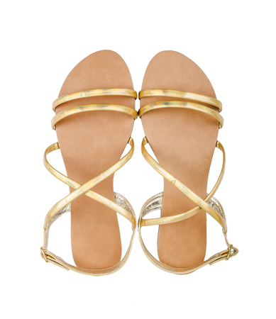 Gold sandals isolated on a white backgroundの写真素材