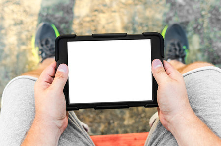 Man with tablet in park or outdoor