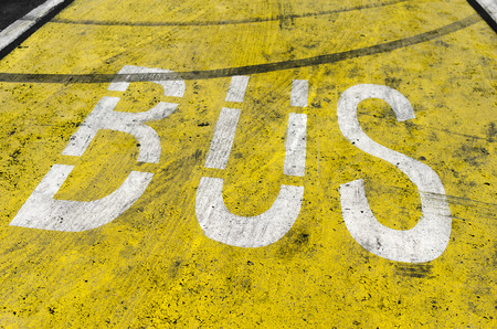 Yellow old bus sign on the roadの写真素材