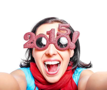 Girl in glasses 2015  taking selfie. New Year`s concept.