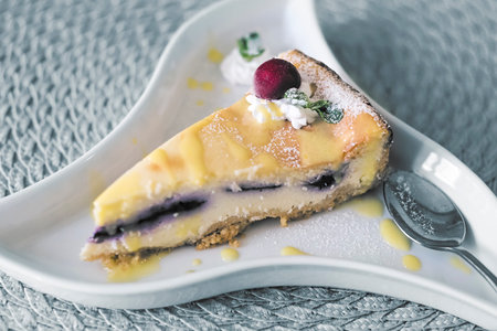 Cherry cheesecake served on antique plate. Toned image.の写真素材