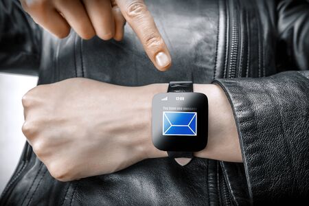 Smart watch. Isolated female body with black smart watch on hand.の写真素材