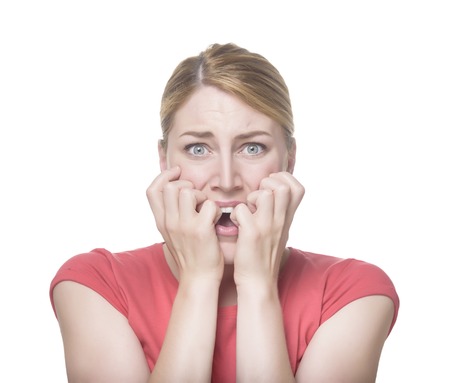 Young cool woman fear face. Isolated on white.の写真素材