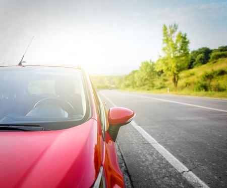Red car on the road at sunset.の写真素材