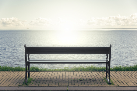 Empty bench on the seafront. Toned photo.の写真素材