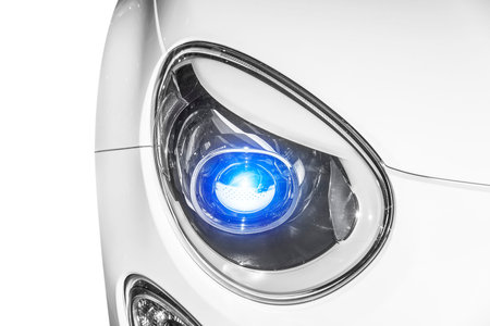 Closeup headlights of car glowing blue color.