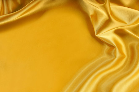 Golden silk texture of  satin abstract background.の写真素材