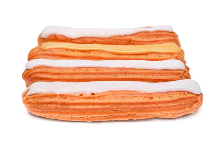 Eclairs with cream isolated on white background.