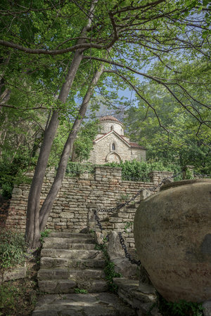 Landscape with ancient monastery in the woods.
