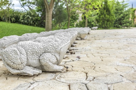 Statues of stone frogs in the park.の写真素材