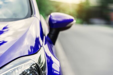 Red automobile on the road at sunset.の写真素材