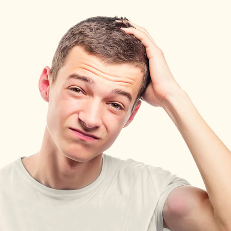 Young man with headache touching forehead. Toned photo.