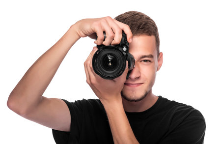 Handsome young man holding a DSLR camera. On white.