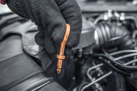 Checking the oil level. Under the hood of the car. Toned photo.の写真素材