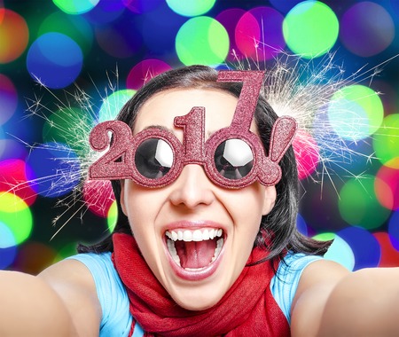 Two thousand and seventeen. 2017. Girl in glasses taking selfie. New Years concept.の写真素材