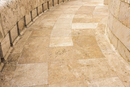 Stone slope or road paved with yellow granite.