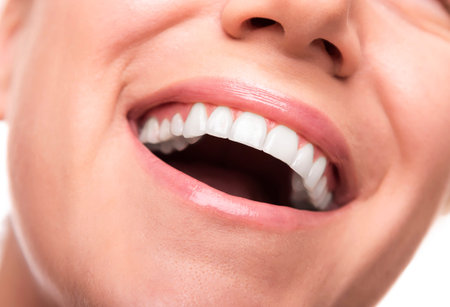 Beautiful wide smile of young woman. Closeup photo.