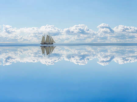 Sailboat sails into the calm in the sea bay.の写真素材