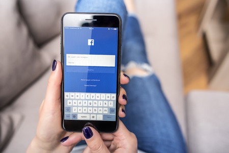 New black iPhone 7 Plus with social network Facebook in hands.のeditorial素材