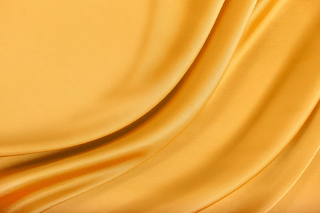 Gold silk texture of satin abstract background.の写真素材