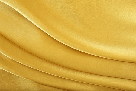 Gold silk texture of satin abstract background.の写真素材