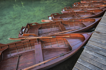 Wooden boats at the pier on the lake in the evening light.の写真素材